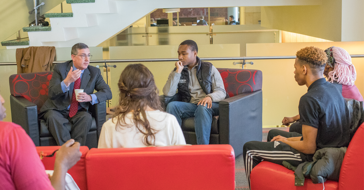 Student talking with the university president